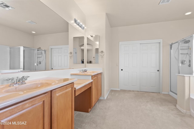 bathroom featuring vanity, a shower stall, baseboards, and visible vents