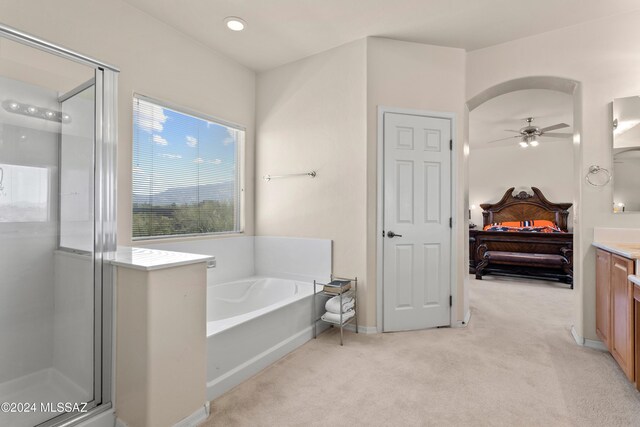 bathroom featuring plus walk in shower, vanity, and ceiling fan