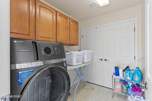 laundry area featuring cabinets and washer / clothes dryer