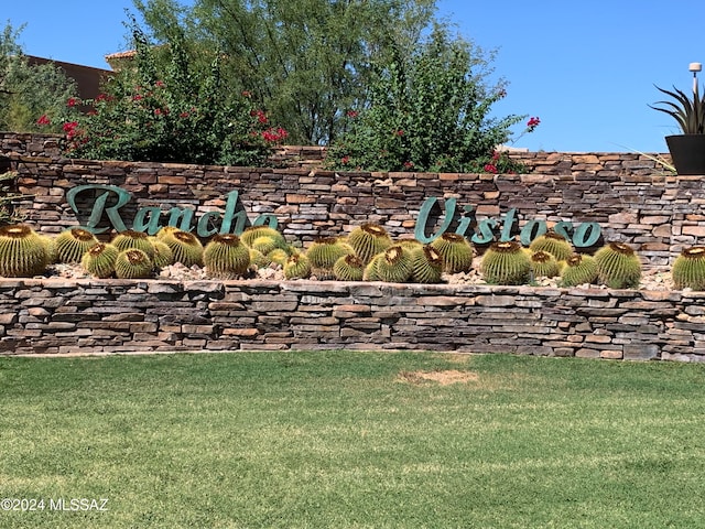 community / neighborhood sign with a lawn