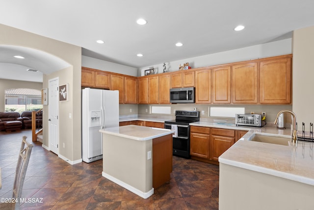 kitchen with black electric range, a center island, white fridge with ice dispenser, and sink