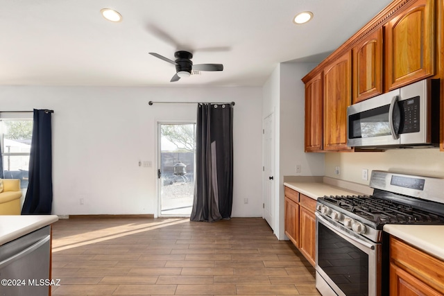 kitchen featuring a healthy amount of sunlight, ceiling fan, stainless steel appliances, and light hardwood / wood-style floors