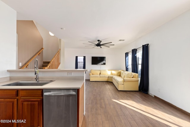 kitchen with dishwasher, ceiling fan, light wood-type flooring, and sink