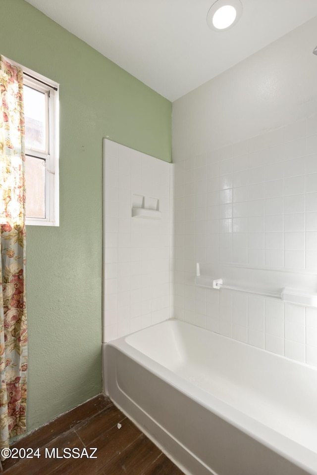 bathroom featuring shower / bathtub combination with curtain and wood-type flooring