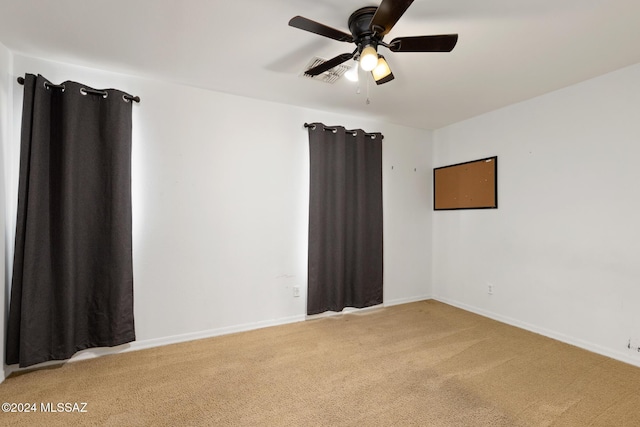 empty room with carpet flooring and ceiling fan