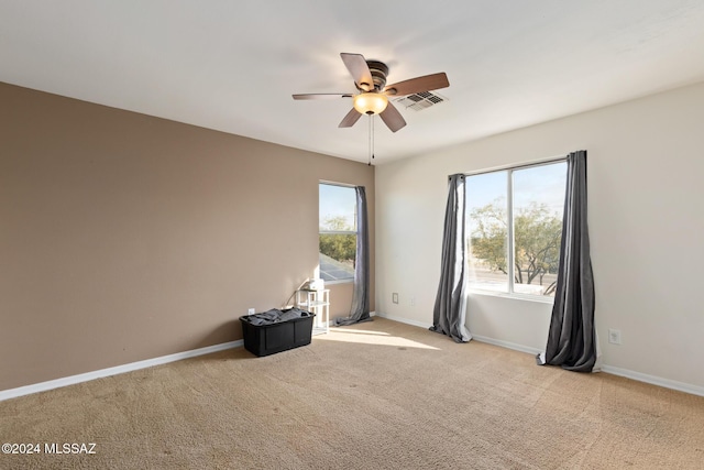 spare room with light carpet and ceiling fan