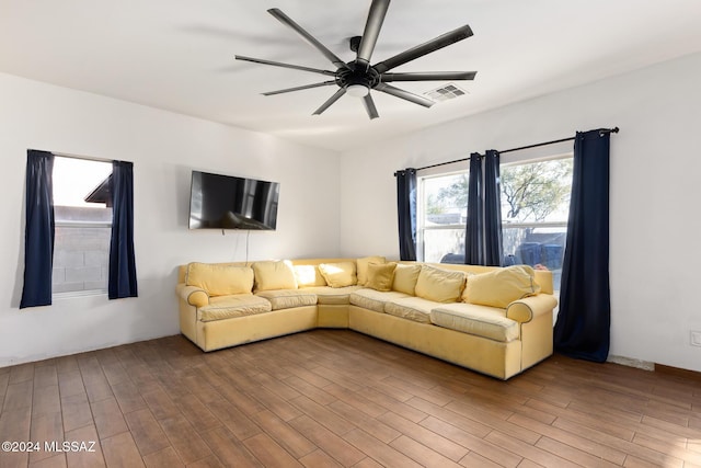 unfurnished living room with hardwood / wood-style flooring and ceiling fan