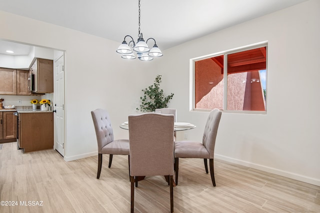 dining area featuring an inviting chandelier and light wood-type flooring