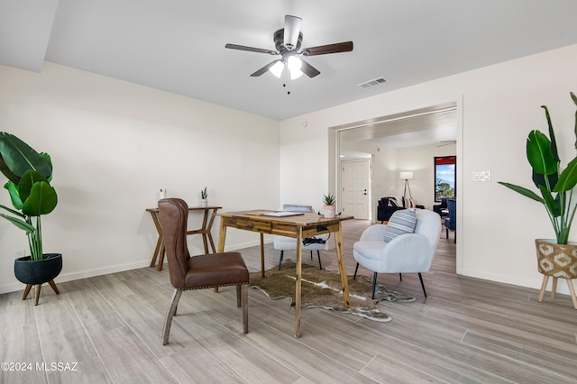 dining space with light hardwood / wood-style floors and ceiling fan