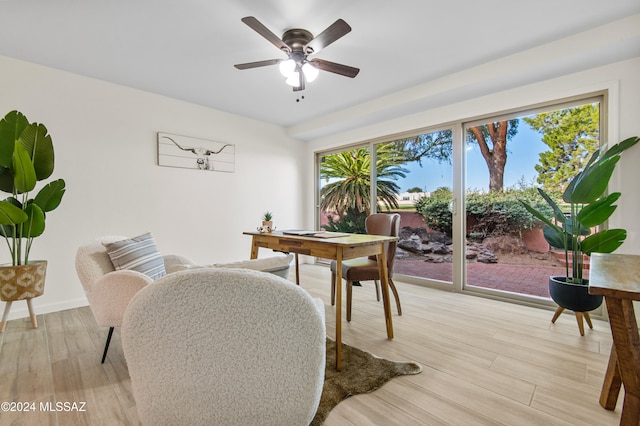 dining room with light wood-type flooring, plenty of natural light, and ceiling fan