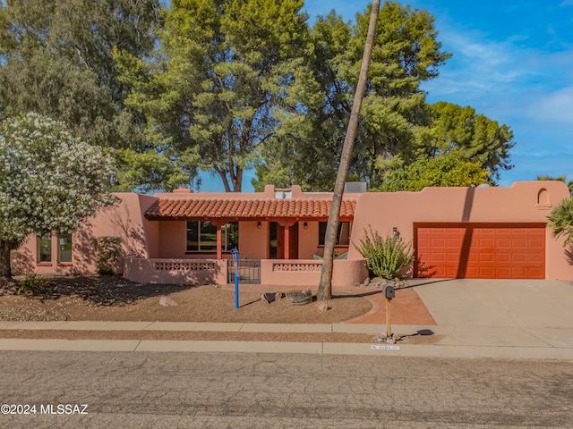 pueblo revival-style home with a garage