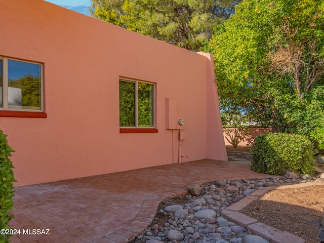 view of side of home with a patio