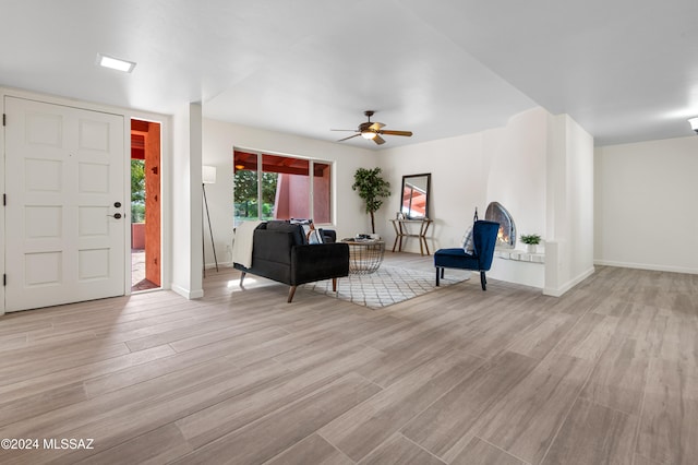 living room featuring ceiling fan and light wood-type flooring