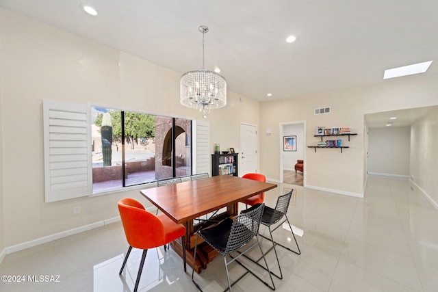 tiled dining space with a chandelier