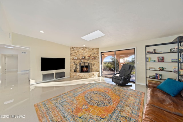 living room featuring a fireplace and a skylight