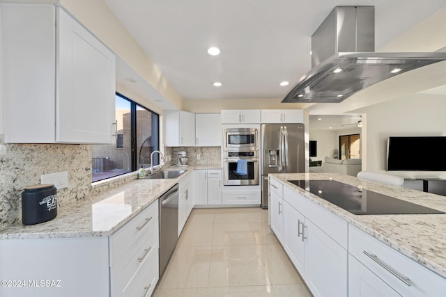 kitchen featuring island exhaust hood, sink, white cabinets, and appliances with stainless steel finishes