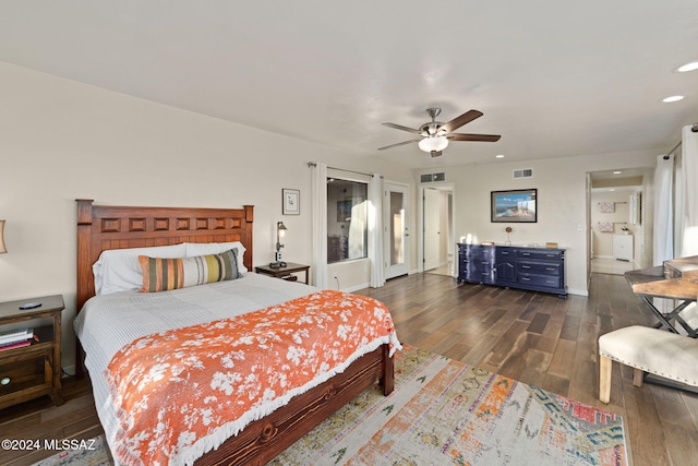 bedroom with dark hardwood / wood-style floors, ceiling fan, and ensuite bath