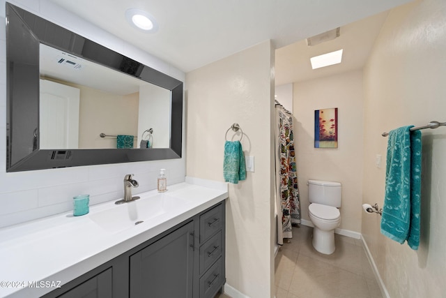 bathroom featuring tile patterned floors, vanity, toilet, and decorative backsplash