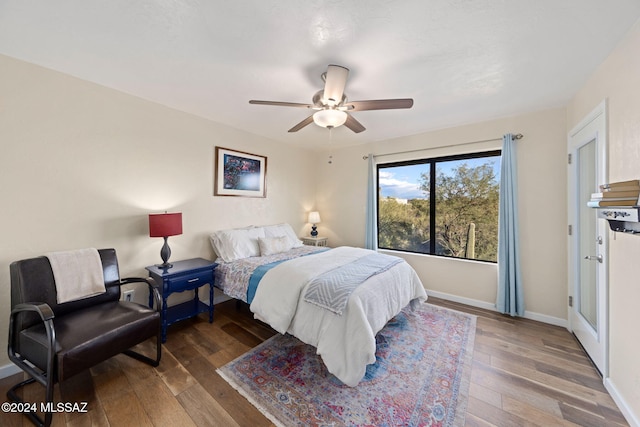 bedroom with wood-type flooring and ceiling fan