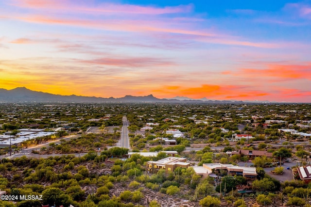 aerial view at dusk featuring a mountain view