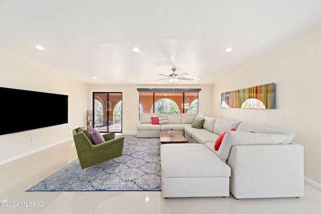 living room with a wealth of natural light, tile patterned flooring, and ceiling fan