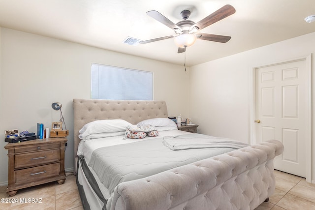 bedroom with ceiling fan and light tile patterned floors