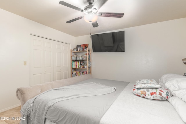 bedroom with ceiling fan and a closet