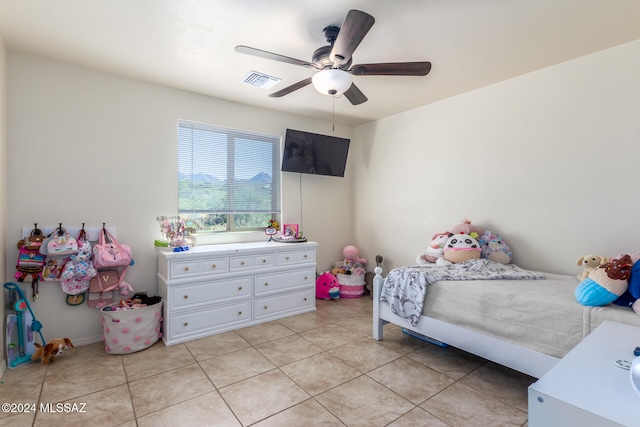 tiled bedroom with ceiling fan