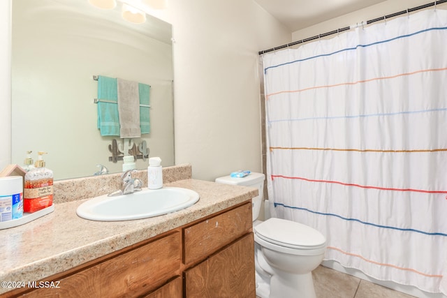 bathroom with toilet, vanity, tile patterned flooring, and curtained shower