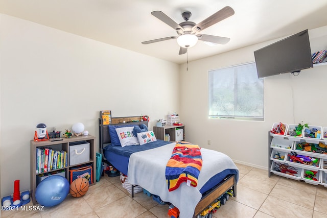 tiled bedroom featuring ceiling fan