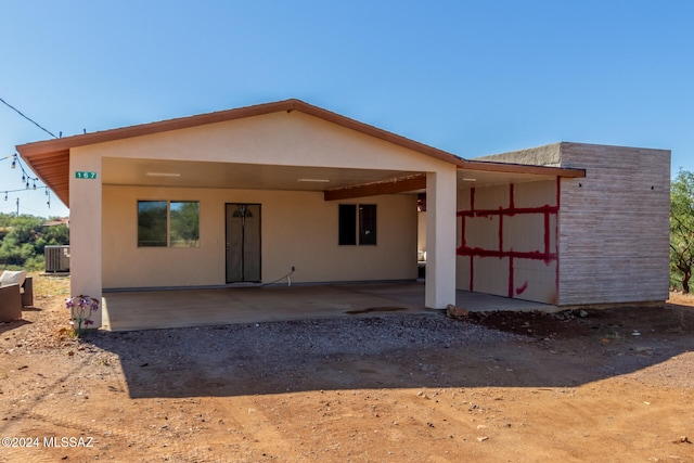 back of house with cooling unit and a patio