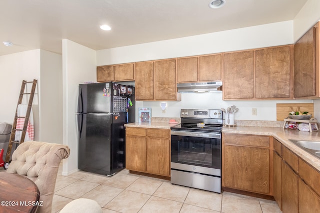 kitchen with black fridge, stainless steel electric range oven, and light tile patterned floors