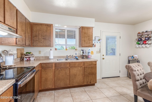 kitchen featuring light tile patterned floors, sink, and stainless steel electric stove