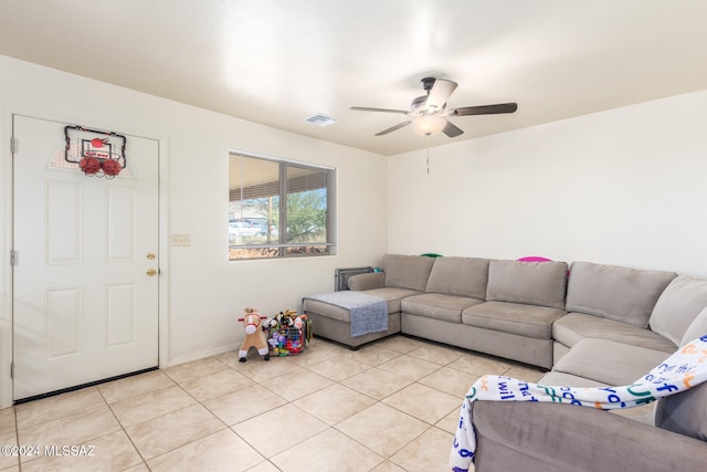 tiled living room with ceiling fan