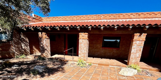 view of side of property featuring a patio