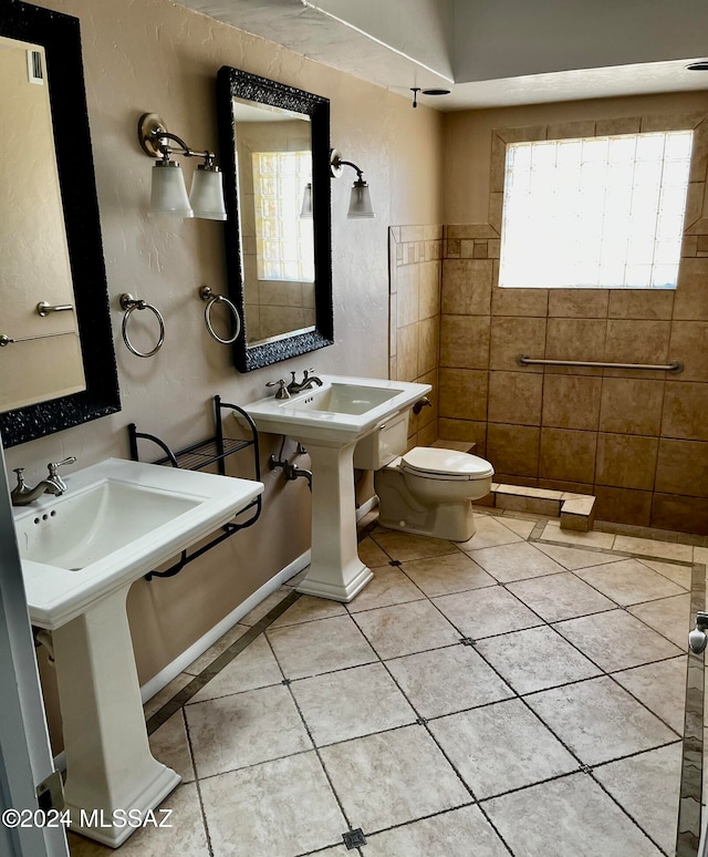 bathroom featuring toilet and tile patterned flooring