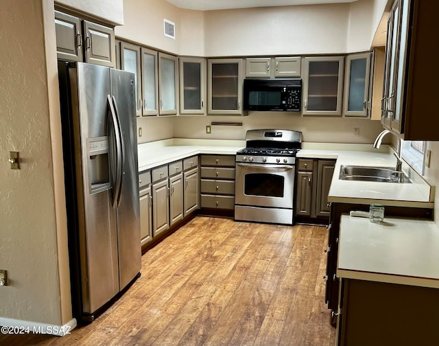 kitchen featuring sink, stainless steel appliances, and light hardwood / wood-style floors