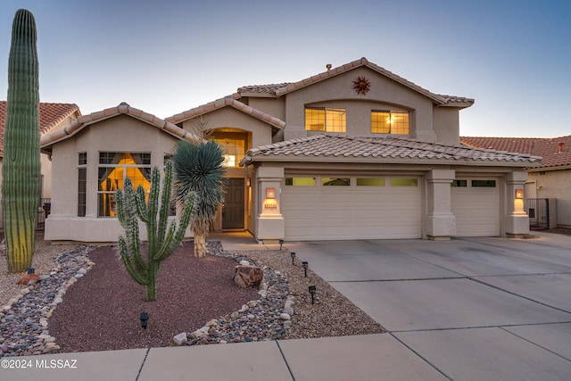 mediterranean / spanish-style home with a garage