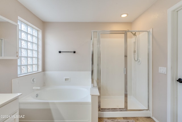 bathroom featuring plus walk in shower and vanity