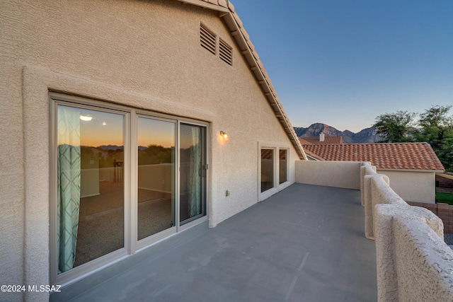 patio terrace at dusk with a mountain view