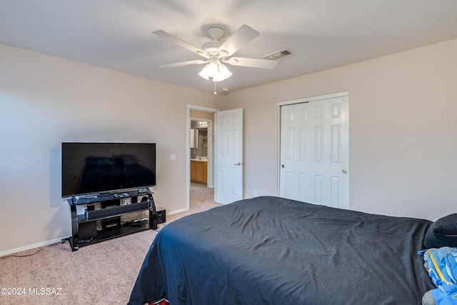 carpeted bedroom featuring a closet and ceiling fan