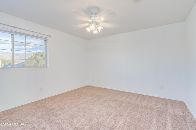 carpeted empty room with ceiling fan