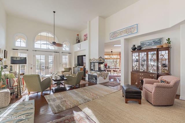 living room featuring a towering ceiling and french doors