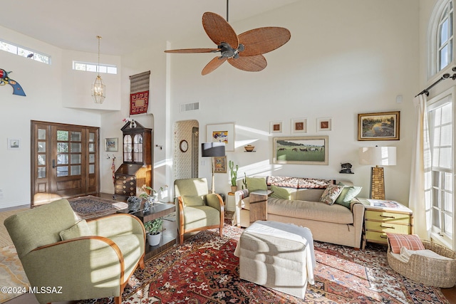 living room featuring a high ceiling and ceiling fan