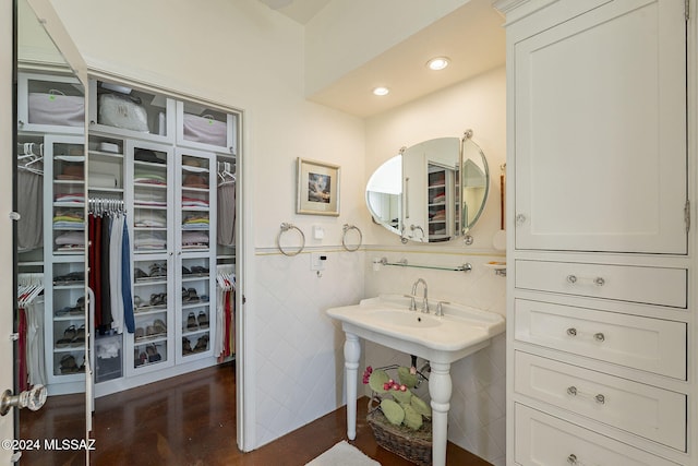 bathroom featuring tile walls and wood-type flooring