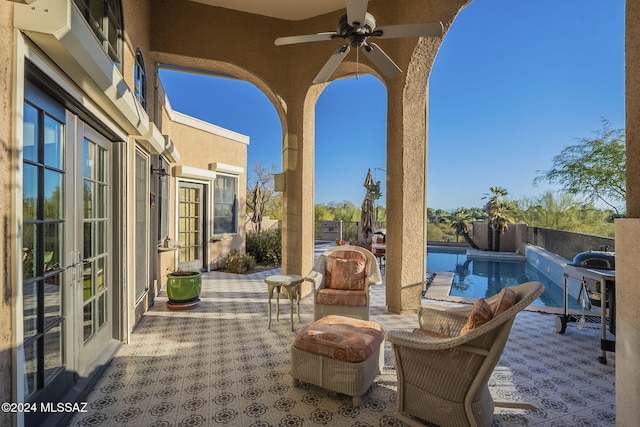 view of patio featuring a fenced in pool, french doors, and ceiling fan