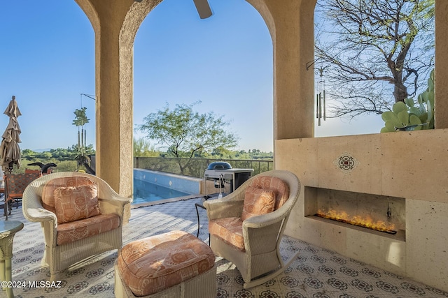 living area featuring an outdoor fireplace