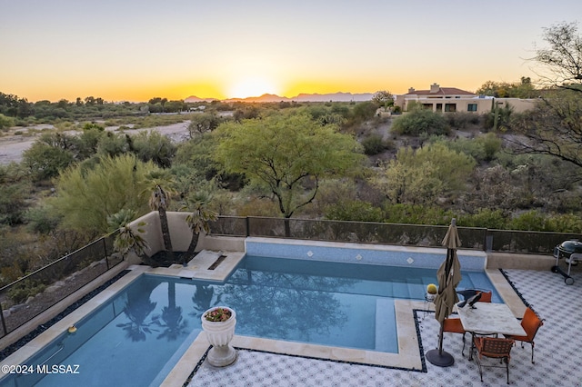 view of pool at dusk