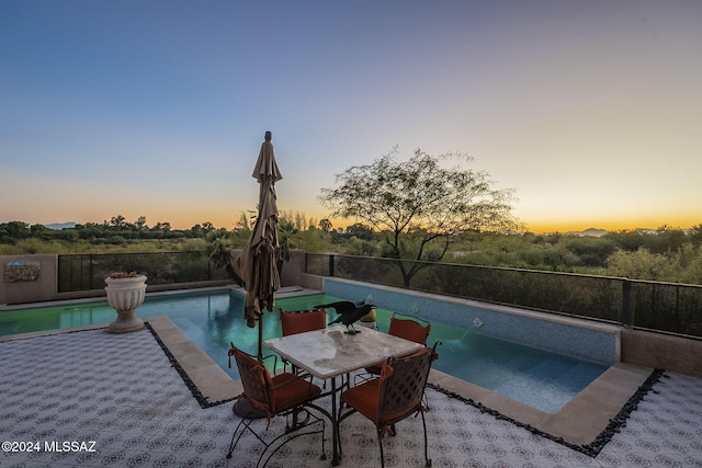 view of pool at dusk