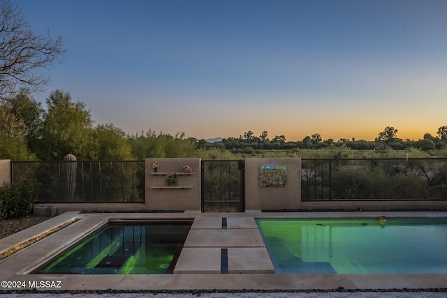 view of pool at dusk